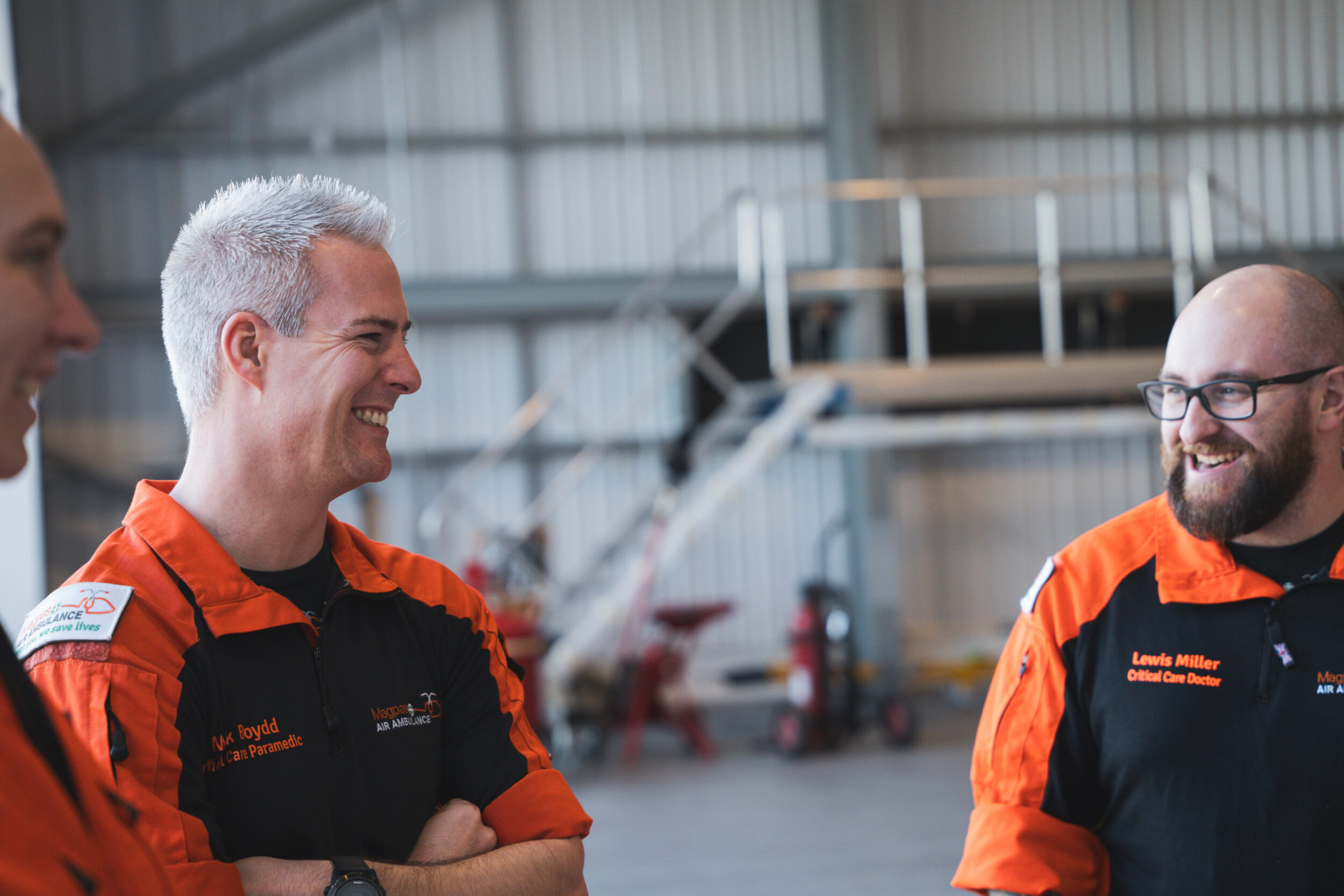 Paramedics and critical care doctors laughing in the MAGPAS Air Ambulance hangar