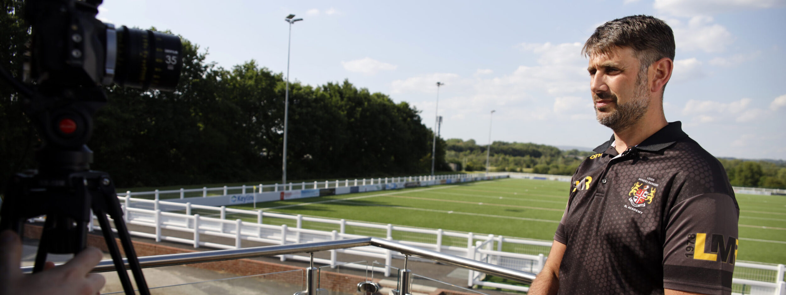 Man talking to camera outside Leigh Miners Rangers Rugby League Academy Club