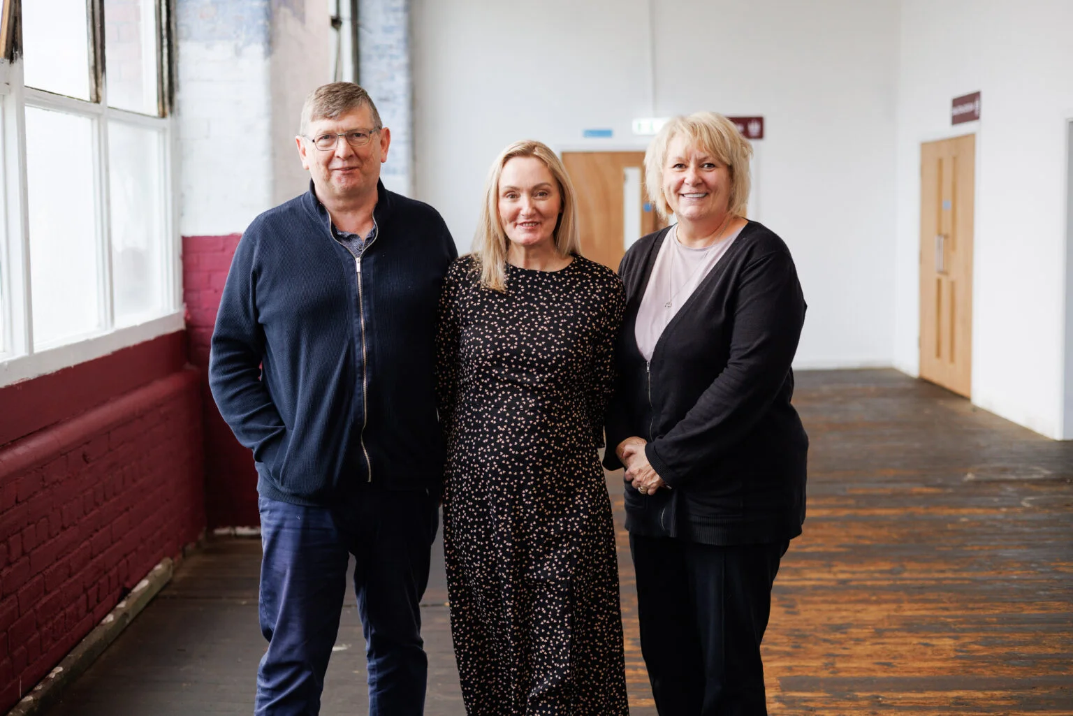 Three people smiling at Leigh Building Preservation Society