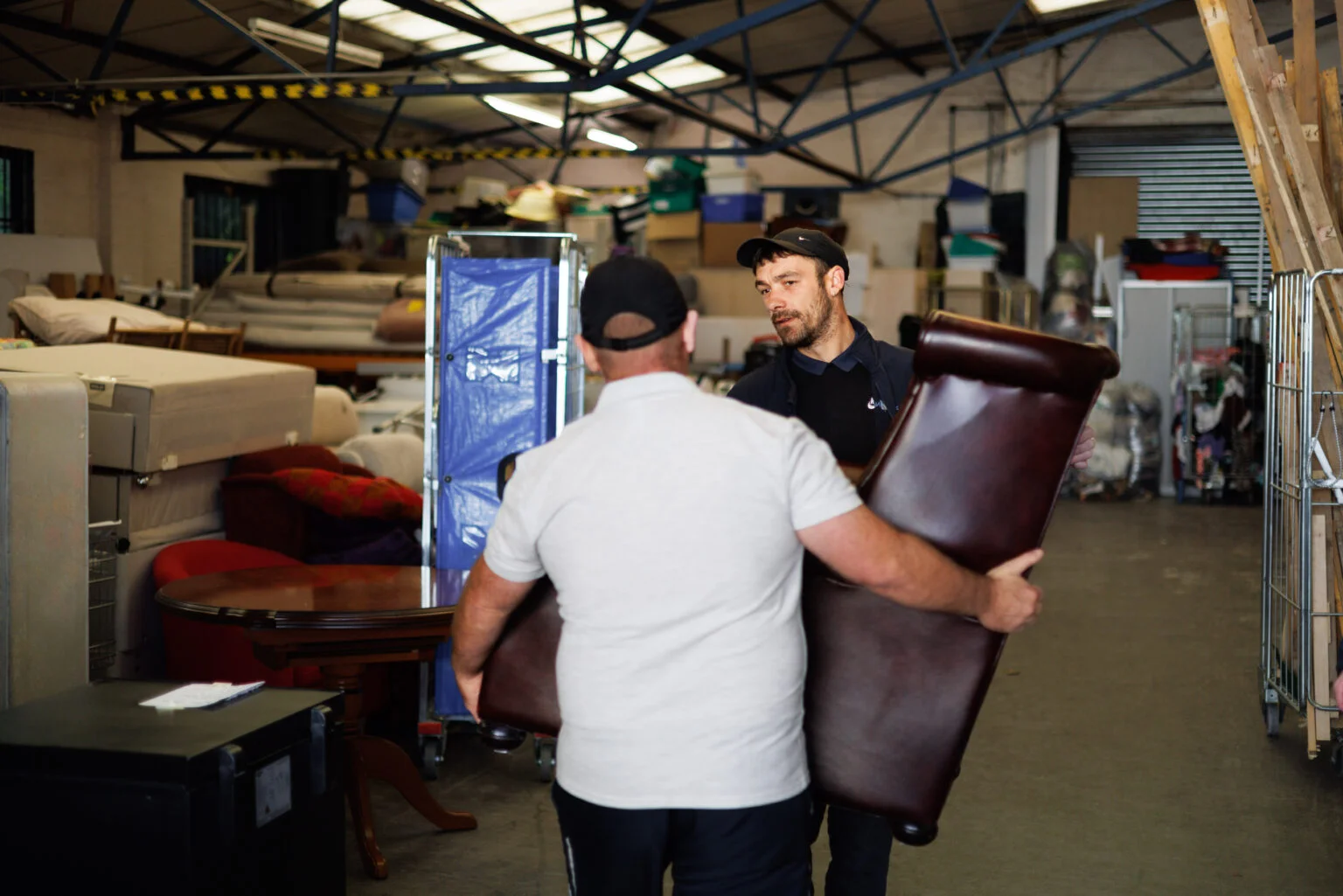 NewStarts Men unloading sofa into warehouse