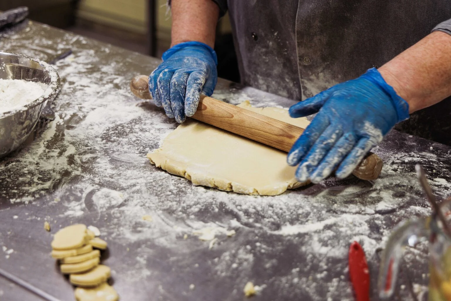 Hands rolling out dough in the kitchen at Praxis Care Northern Ireland